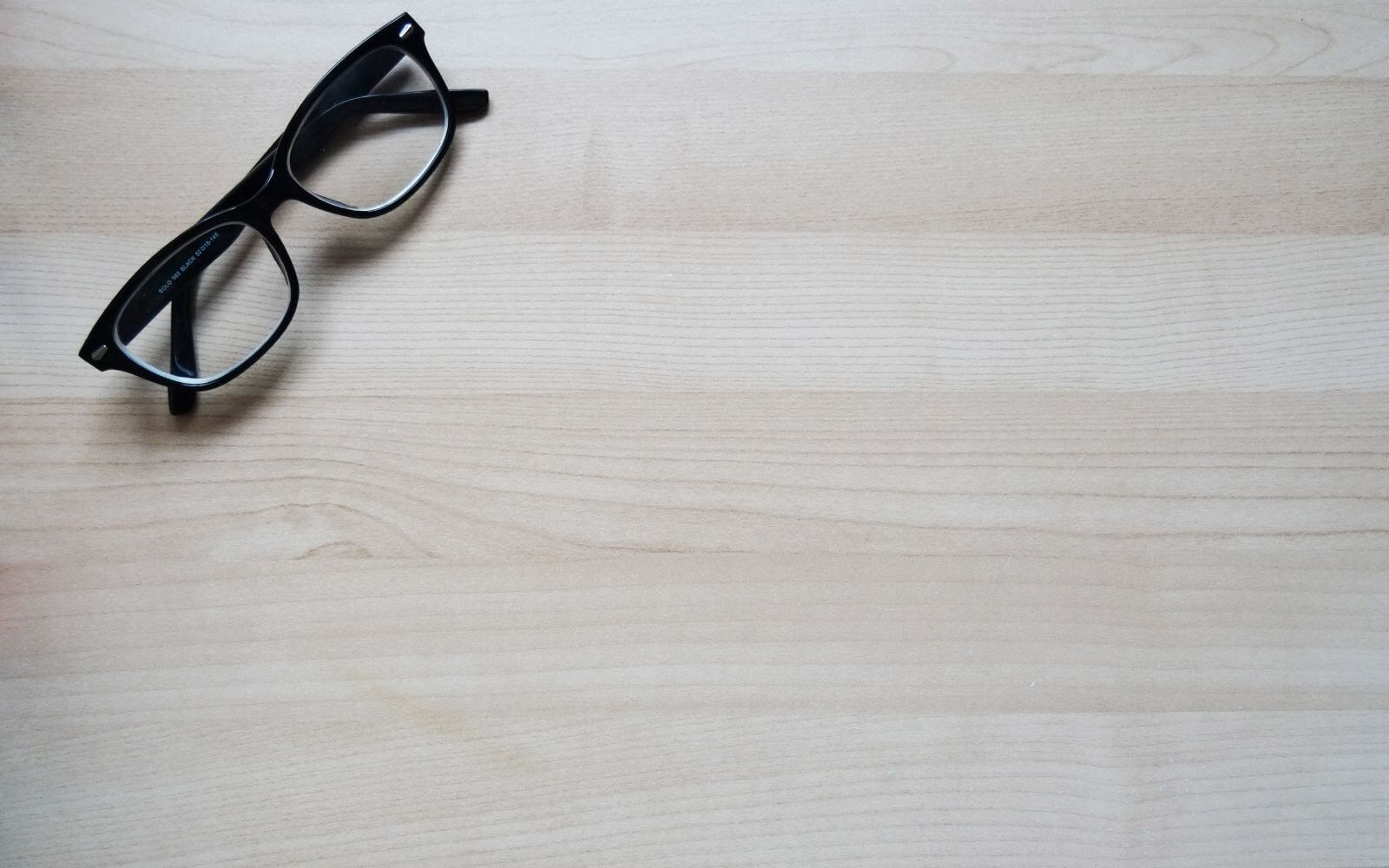 Glasses on wood desk represent focus on emerging beverage brands